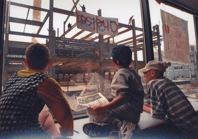 Patients watching construction workers right their names on beams