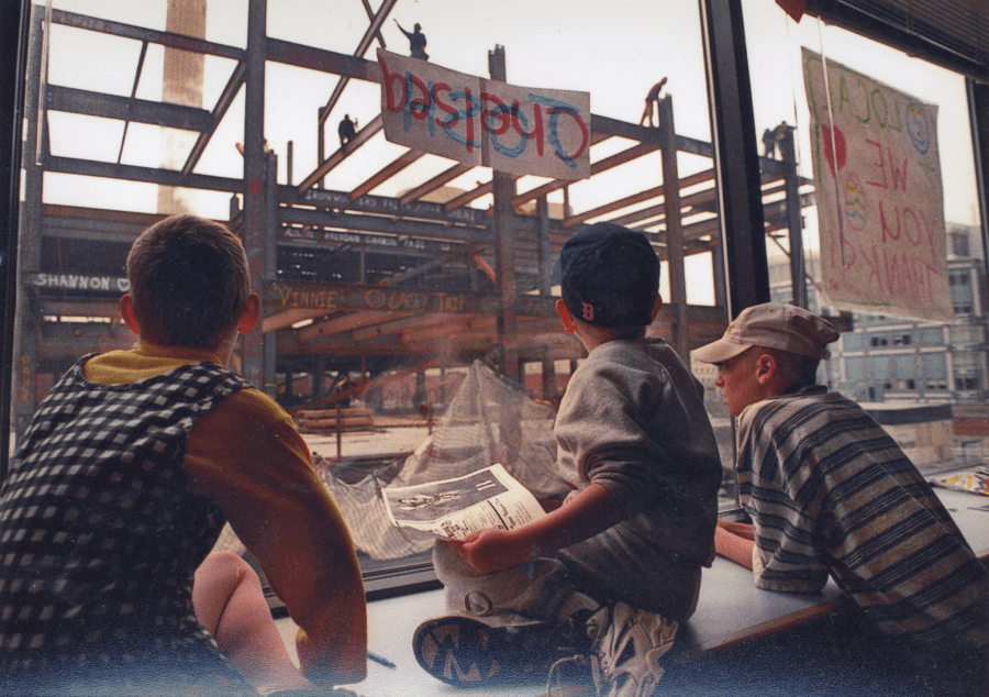 Patients watching construction workers write their names on beams
