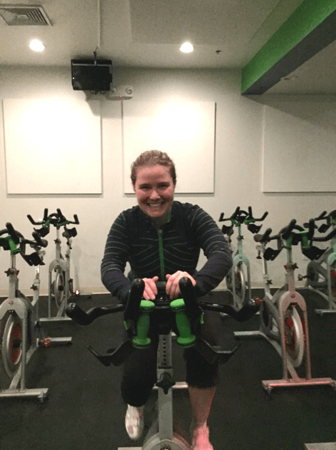 Kelly pedals a stationary bike